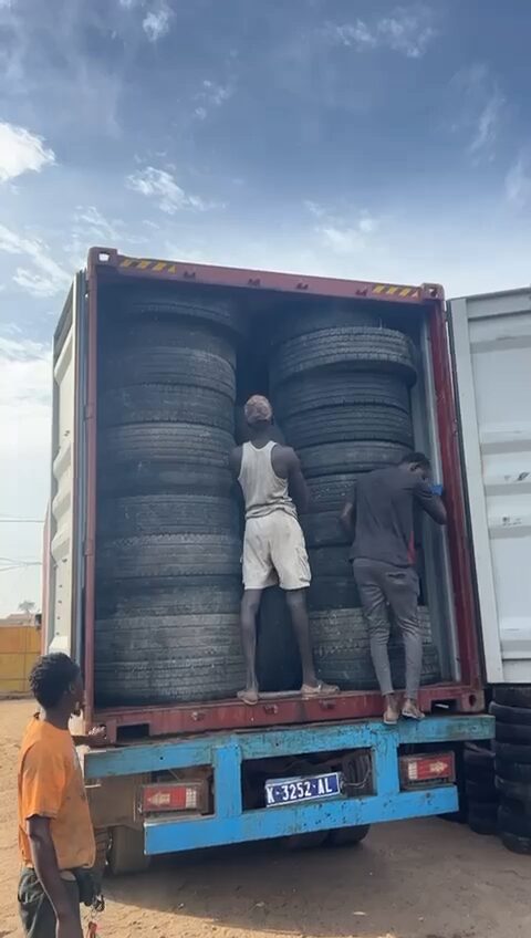 Crew unloading tyres from the container