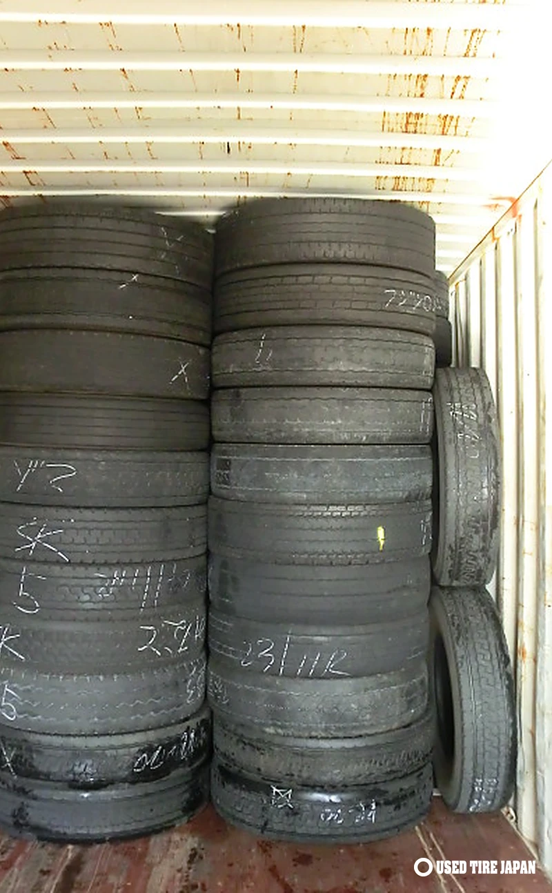 Used 11R22.5 truck tires stacked in container before shipment, December 2025