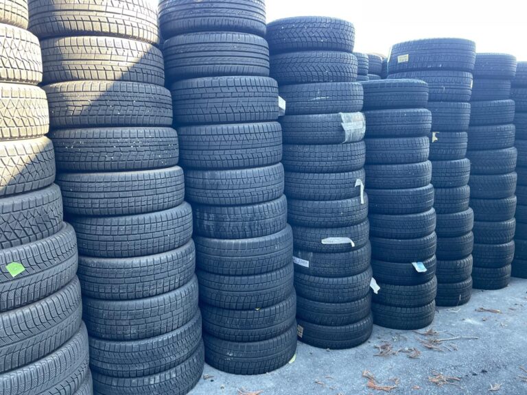 Rows of used passenger car tyres stacked at the yard in Japan before the July 2026 container loadings